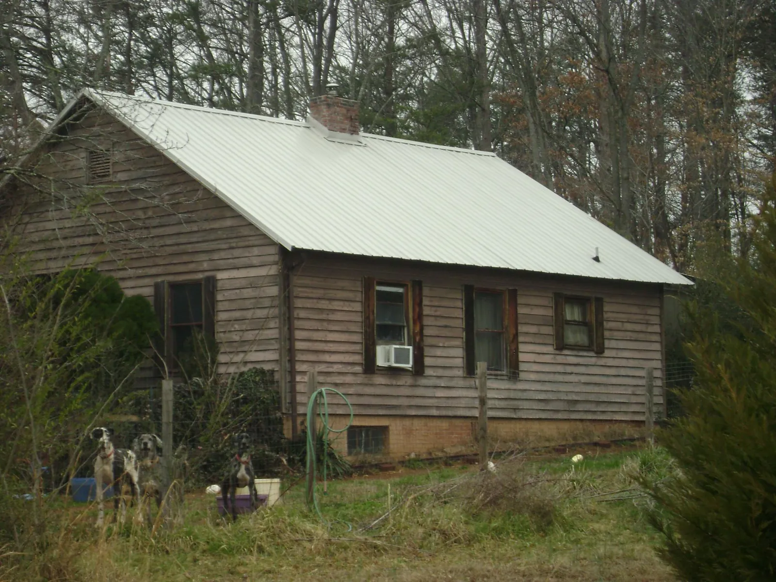 White metal roof on an old wood sided farmhouse, from a Metal Roof Installation job in Florida